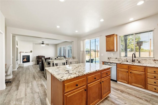 33883 Vinca Ln, Murrieta, CA 92563 - kitchen with dishwasher, light wood-style flooring, recessed lighting, light stone countertops, and ceiling fan