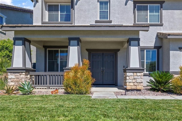 33883 Vinca Ln, Murrieta, CA 92563 - entrance to property with stucco siding, stone siding, covered porch, and a yard