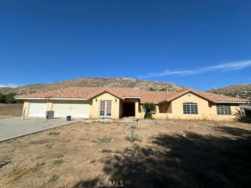 35075 Firecat Rd, Hemet, CA 92545 - single story home with a mountain view, stucco siding, concrete driveway, a garage, and a tiled roof