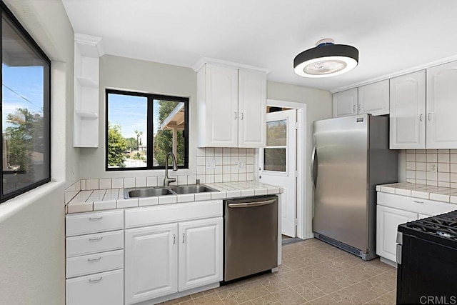 3976 N Granada Ave, Spring Valley, CA 91977 - kitchen featuring appliances with stainless steel finishes, tile counters, and white cabinets
