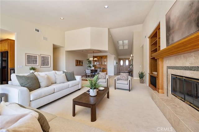 822 Noddy Ct, Arroyo Grande, CA 93420 - living room with built in shelves, recessed lighting, light colored carpet, a high end fireplace, and a high ceiling
