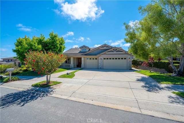 822 Noddy Ct, Arroyo Grande, CA 93420 - view of front of home with a garage, driveway, stone siding, and a front lawn
