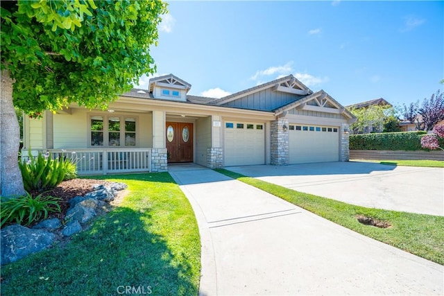 822 Noddy Ct, Arroyo Grande, CA 93420 - view of front of house featuring a garage, a porch, driveway, and stone siding