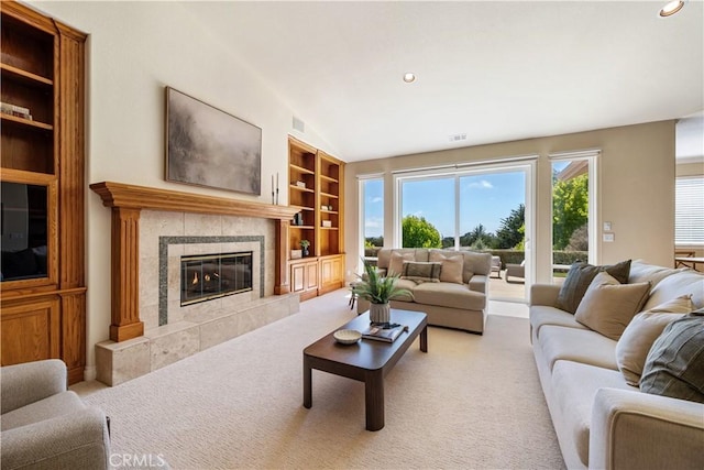 822 Noddy Ct, Arroyo Grande, CA 93420 - living room with built in shelves, a fireplace, vaulted ceiling, light carpet, and recessed lighting