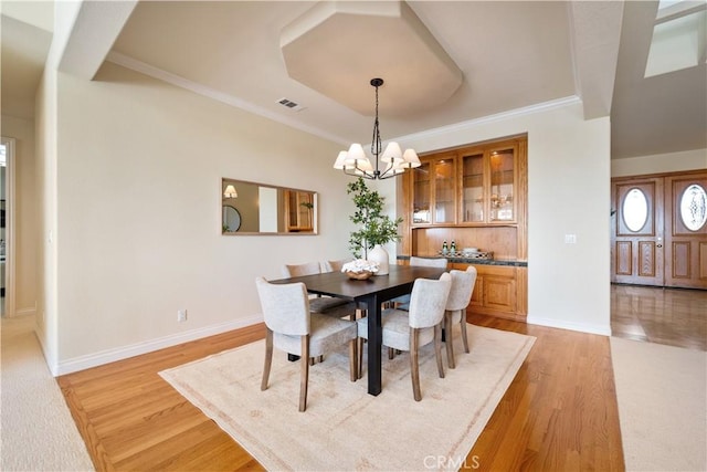 822 Noddy Ct, Arroyo Grande, CA 93420 - dining space featuring light wood finished floors, a chandelier, and ornamental molding