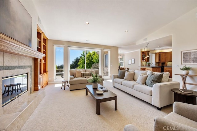 822 Noddy Ct, Arroyo Grande, CA 93420 - living room featuring light carpet, a tiled fireplace, recessed lighting, and built in features