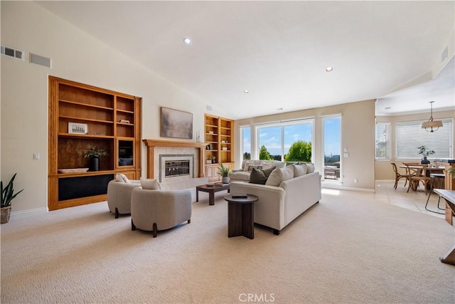 822 Noddy Ct, Arroyo Grande, CA 93420 - living room with light carpet, lofted ceiling, a tiled fireplace, recessed lighting, and built in shelves