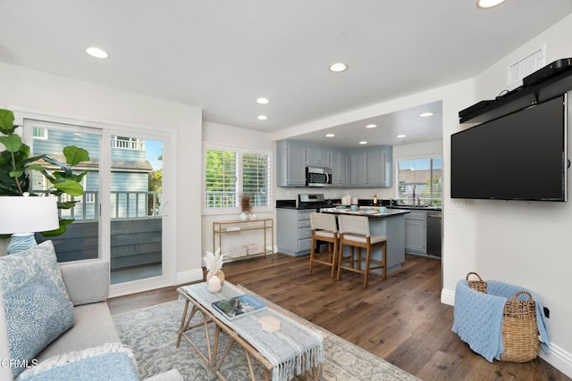 1051 Thomas Ln, Ventura, CA 93003 - living area with recessed lighting and dark wood-style flooring