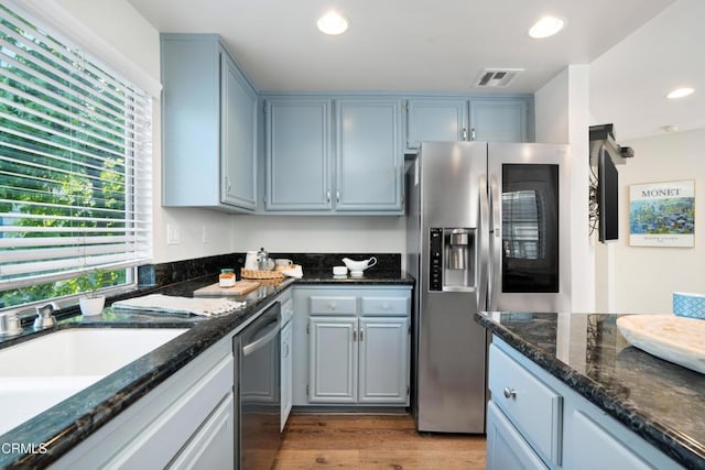 1051 Thomas Ln, Ventura, CA 93003 - kitchen featuring stainless steel appliances, dark stone countertops, recessed lighting, and wood finished floors