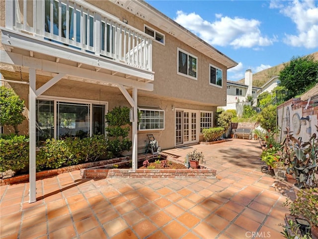 28702 Eagleton St, Agoura Hills, CA 91301 - rear view of house featuring a balcony, a patio area, french doors, and stucco siding