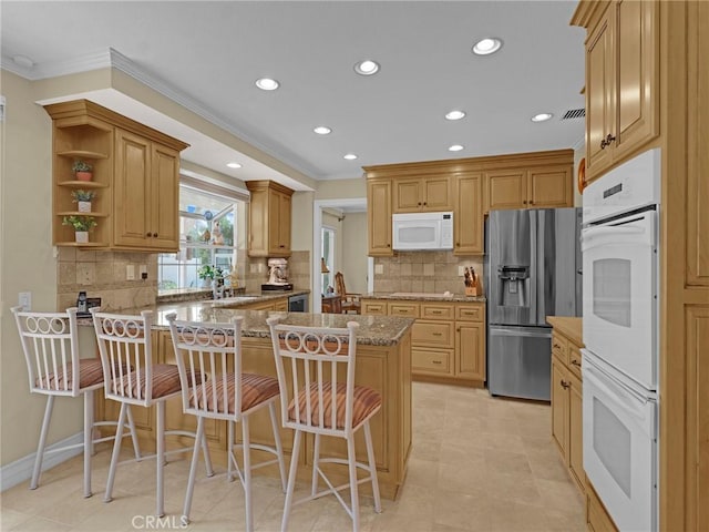 28702 Eagleton St, Agoura Hills, CA 91301 - kitchen featuring white appliances, a peninsula, ornamental molding, recessed lighting, and a breakfast bar
