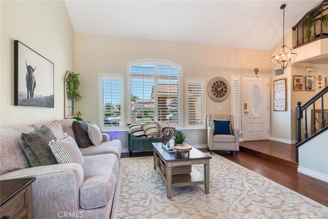 6915 Stanislaus Pl, Rancho Cucamonga, CA 91701 - living room with a chandelier, wood finished floors, stairway, and vaulted ceiling