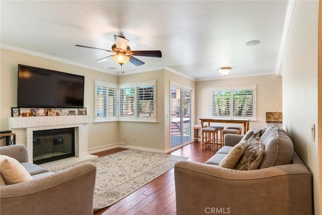 6915 Stanislaus Pl, Rancho Cucamonga, CA 91701 - living area featuring dark wood-type flooring, ornamental molding, a ceiling fan, and a fireplace