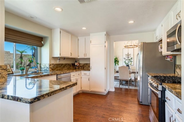 6915 Stanislaus Pl, Rancho Cucamonga, CA 91701 - kitchen with stainless steel appliances, dark wood-type flooring, white cabinetry, a chandelier, and recessed lighting