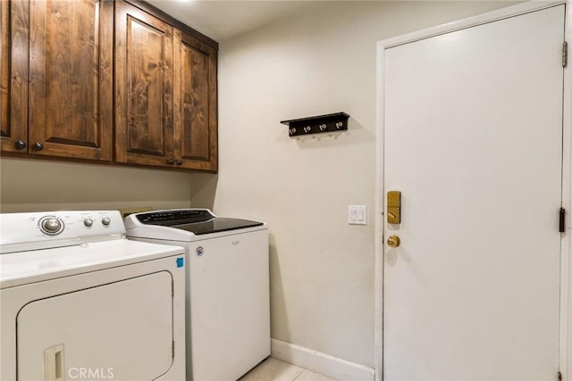 6915 Stanislaus Pl, Rancho Cucamonga, CA 91701 - washroom with washer and dryer, cabinet space, and light tile patterned floors