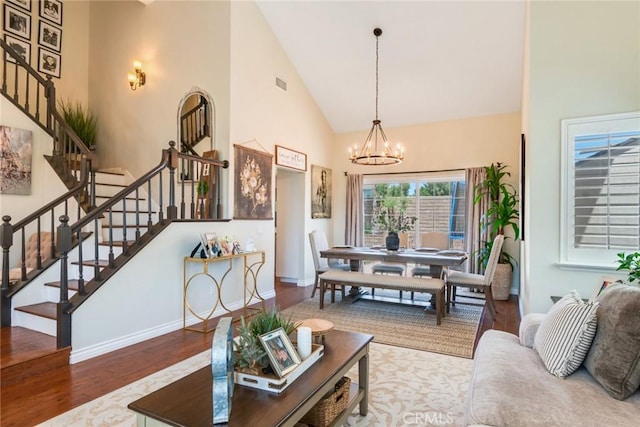 6915 Stanislaus Pl, Rancho Cucamonga, CA 91701 - living room featuring wood finished floors, high vaulted ceiling, stairway, and a chandelier