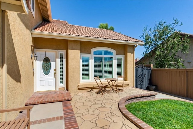 6915 Stanislaus Pl, Rancho Cucamonga, CA 91701 - entrance to property with stucco siding, a patio area, and a gate
