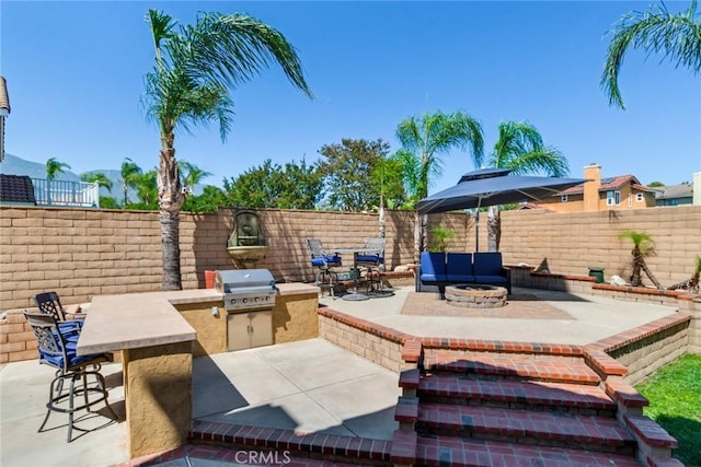 6915 Stanislaus Pl, Rancho Cucamonga, CA 91701 - fenced backyard featuring an outdoor fire pit, an outdoor kitchen, a patio area, and an outdoor bar