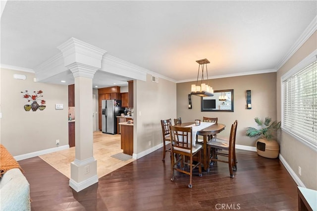39981 Golfers Ln, Palmdale, CA 93551 - dining room with ornate columns, wood finished floors, crown molding, a chandelier, and recessed lighting