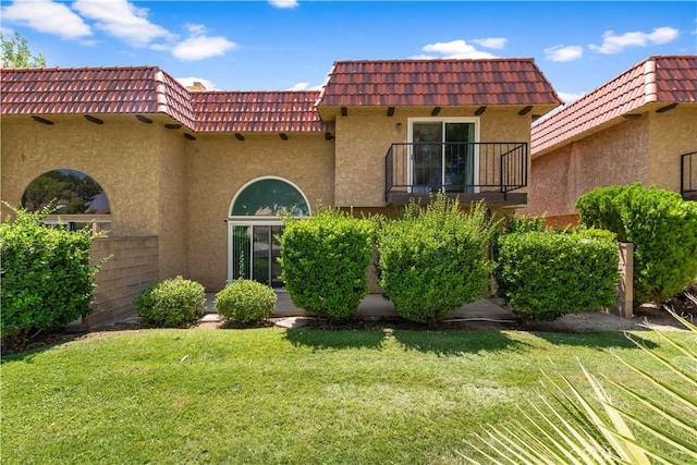 39981 Golfers Ln, Palmdale, CA 93551 - view of front facade with a balcony, a tiled roof, and stucco siding