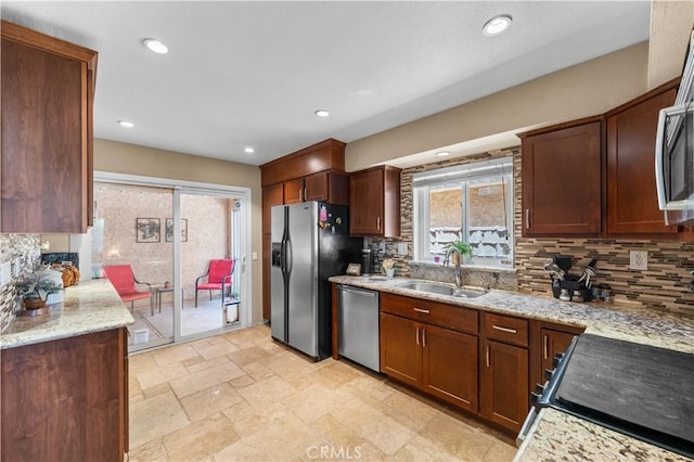 39981 Golfers Ln, Palmdale, CA 93551 - kitchen featuring appliances with stainless steel finishes, backsplash, stone tile flooring, light stone countertops, and recessed lighting
