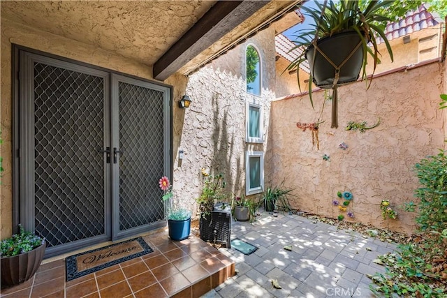 39981 Golfers Ln, Palmdale, CA 93551 - doorway to property with stucco siding and a patio area