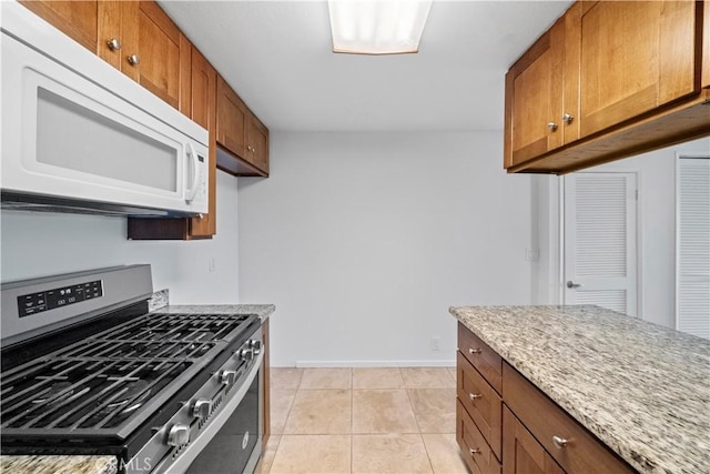 2501 S El Camino Real, San Clemente, CA 92672 - kitchen with gas range, white microwave, brown cabinets, and light stone counters