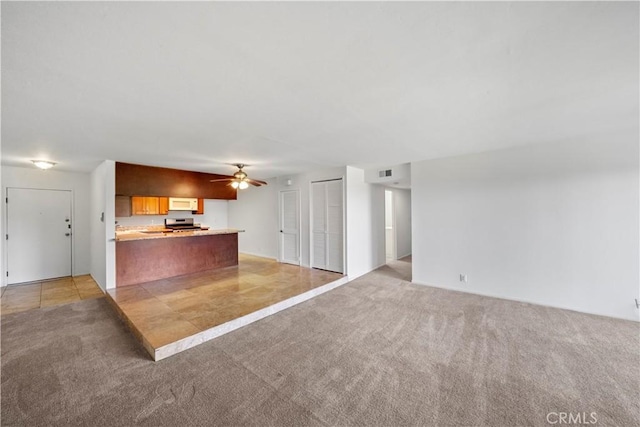 2501 S El Camino Real, San Clemente, CA 92672 - unfurnished living room featuring light colored carpet and a ceiling fan