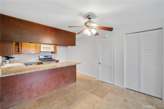 2501 S El Camino Real, San Clemente, CA 92672 - kitchen featuring appliances with stainless steel finishes, a peninsula, ceiling fan, glass insert cabinets, and light stone countertops