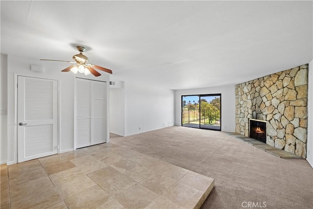 2501 S El Camino Real, San Clemente, CA 92672 - unfurnished living room featuring ceiling fan, a stone fireplace, and light colored carpet
