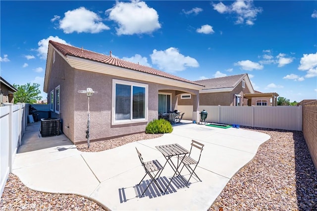 19385 Boulder St, Apple Valley, CA 92308 - rear view of house with stucco siding, a fenced backyard, a tiled roof, and a patio