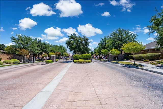 19385 Boulder St, Apple Valley, CA 92308 - view of street featuring a gated entry, sidewalks, curbs, and a gate