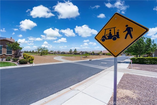 19385 Boulder St, Apple Valley, CA 92308 - view of asphalt road featuring curbs, traffic signs, and a residential view