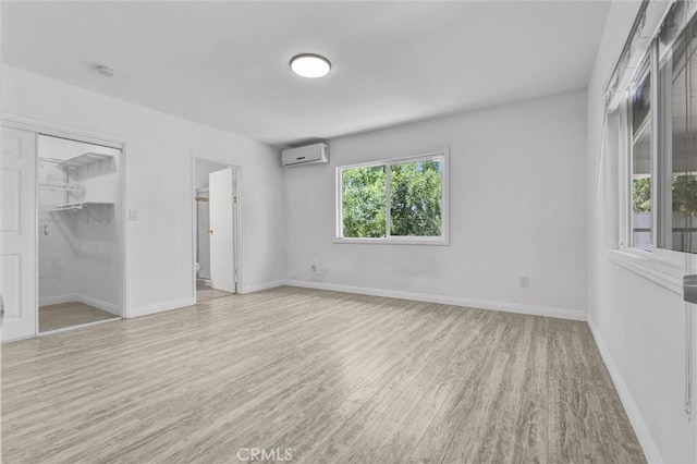 4449 Walnut St, Baldwin Park, CA 91706 - unfurnished bedroom with a wall mounted air conditioner, wood finished floors, and ensuite bathroom