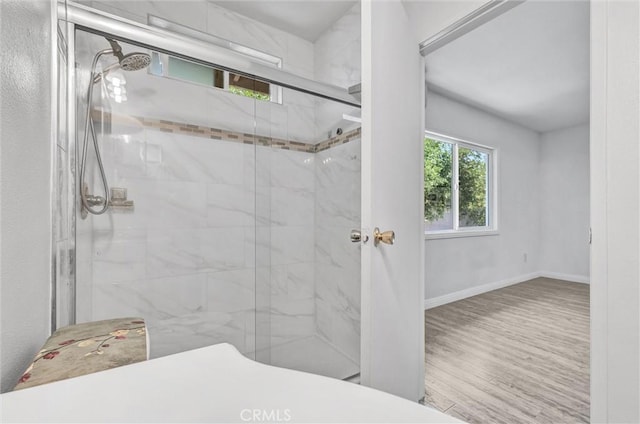 4449 Walnut St, Baldwin Park, CA 91706 - bathroom with a marble finish shower and wood finished floors