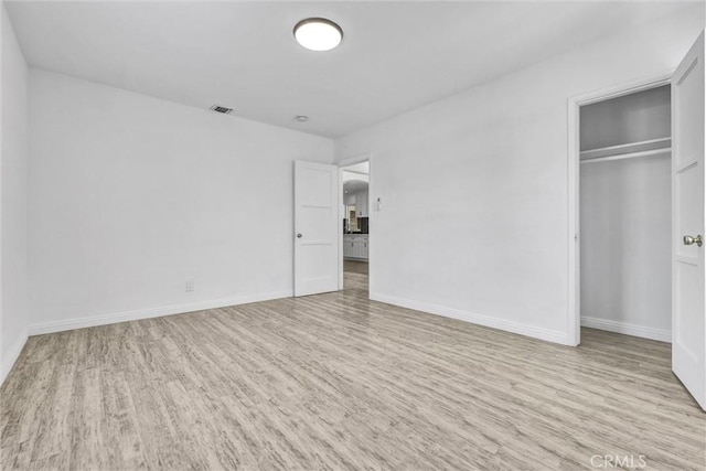 4449 Walnut St, Baldwin Park, CA 91706 - unfurnished bedroom featuring wood finished floors, arched walkways, and a closet