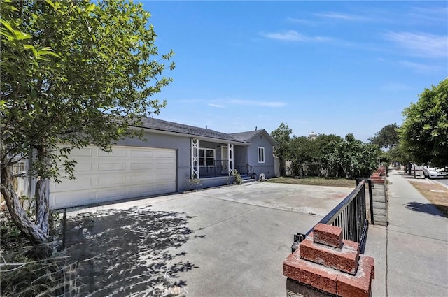 4449 Walnut St, Baldwin Park, CA 91706 - view of front facade with stucco siding, an attached garage, and driveway