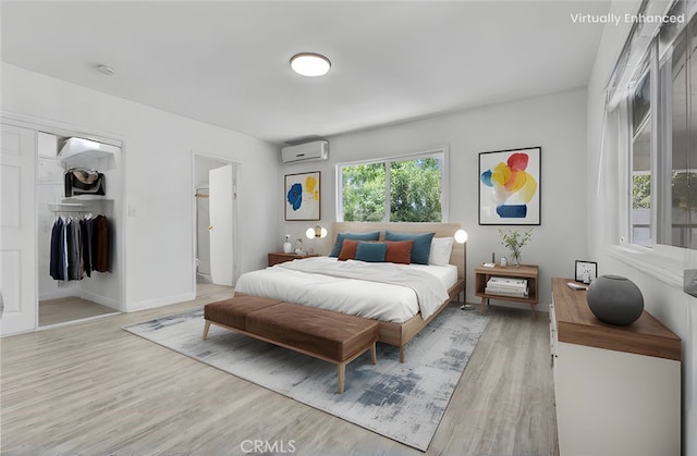 4449 Walnut St, Baldwin Park, CA 91706 - bedroom with a wall mounted AC, light wood-style flooring, and connected bathroom