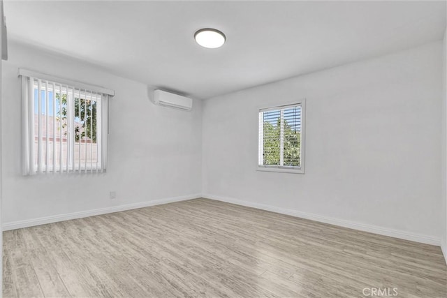 4449 Walnut St, Baldwin Park, CA 91706 - spare room featuring a wall unit AC and wood finished floors