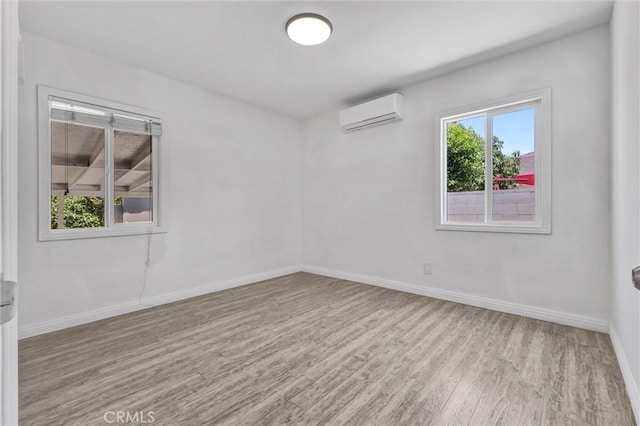 4449 Walnut St, Baldwin Park, CA 91706 - empty room featuring wood finished floors and an AC wall unit