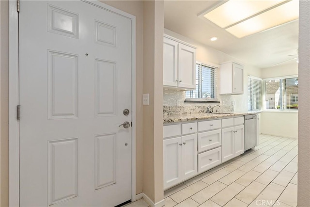 1158 Pacific Pointe Way, Arroyo Grande, CA 93420 - kitchen with stainless steel dishwasher, white cabinets, light tile patterned floors, recessed lighting, and decorative backsplash
