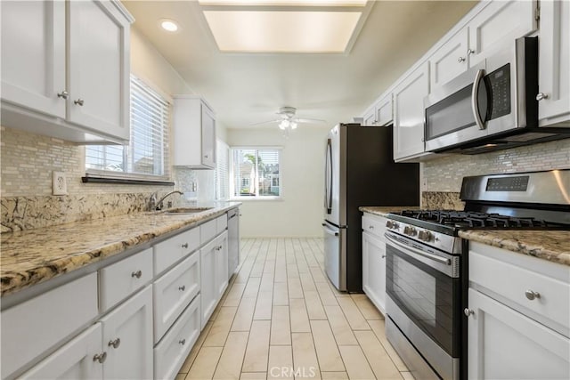 1158 Pacific Pointe Way, Arroyo Grande, CA 93420 - kitchen with appliances with stainless steel finishes, ceiling fan, decorative backsplash, white cabinetry, and recessed lighting