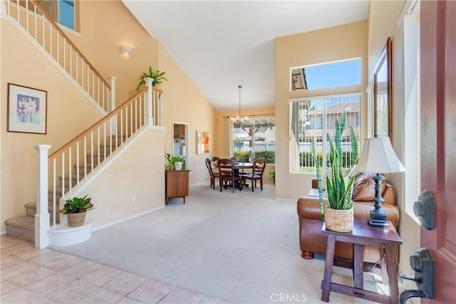 20776 Freeport Dr, Riverside, CA 92508 - tiled living area with high vaulted ceiling, stairs, carpet flooring, and a chandelier