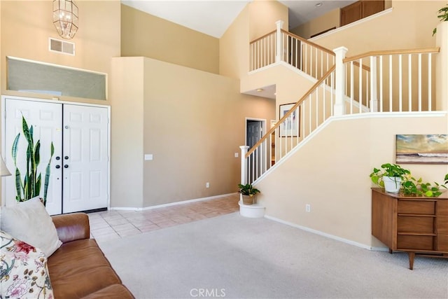 20776 Freeport Dr, Riverside, CA 92508 - tiled foyer entrance featuring a high ceiling, stairway, and carpet floors