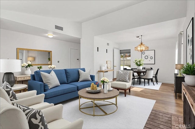 6355 Ortega St, Chino, CA 91710 - living room with light wood-style flooring and a chandelier