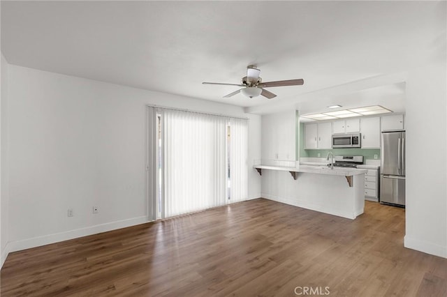 6355 Ortega St, Chino, CA 91710 - unfurnished living room with ceiling fan and wood finished floors