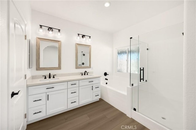 4082 N Flame Tree Ave, Rialto, CA 92377 - full bathroom with a garden tub, double vanity, a stall shower, and wood finished floors