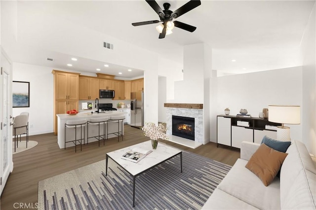 4082 N Flame Tree Ave, Rialto, CA 92377 - living area featuring light wood-style floors, recessed lighting, ceiling fan, and a fireplace