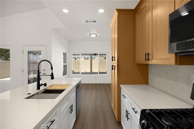 4082 N Flame Tree Ave, Rialto, CA 92377 - kitchen featuring black range with gas stovetop, stainless steel dishwasher, dark wood finished floors, recessed lighting, and light stone countertops