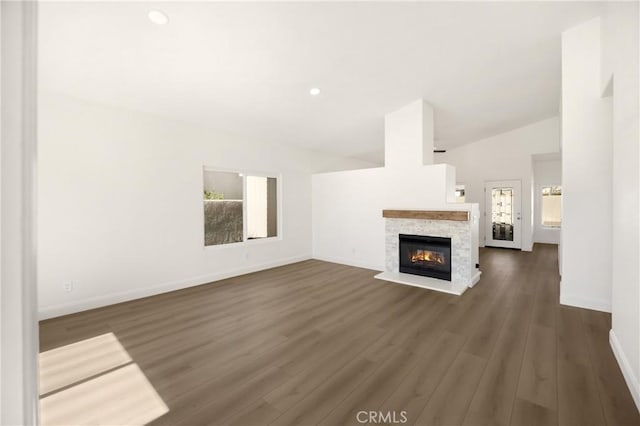 4082 N Flame Tree Ave, Rialto, CA 92377 - unfurnished living room featuring a stone fireplace, wood finished floors, recessed lighting, and vaulted ceiling